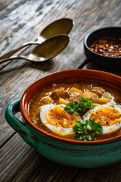 istock Potato sausage soup with boiled egg on wooden table 2248471169