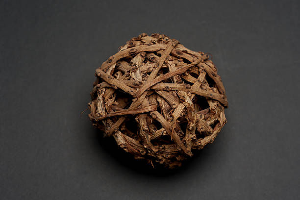 Hand made and painted wooden sphere on black background