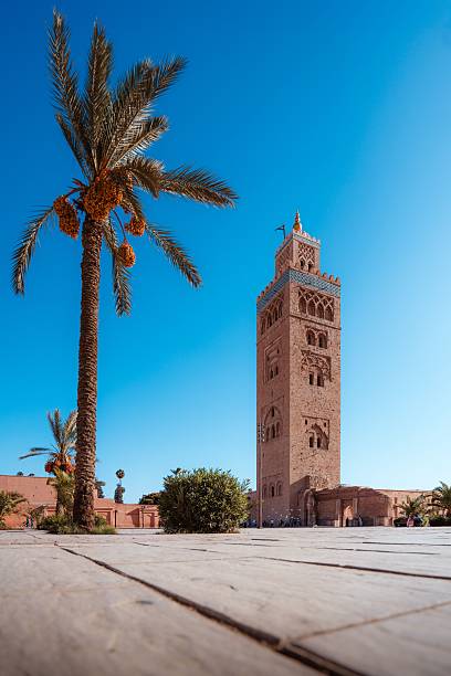 istock Koutoubia Mosque in Marrakech, Morocco, with a palm tree under a clear blue sky. 2248472171