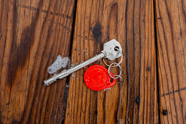 Lost house keys are lying on a bench in winter