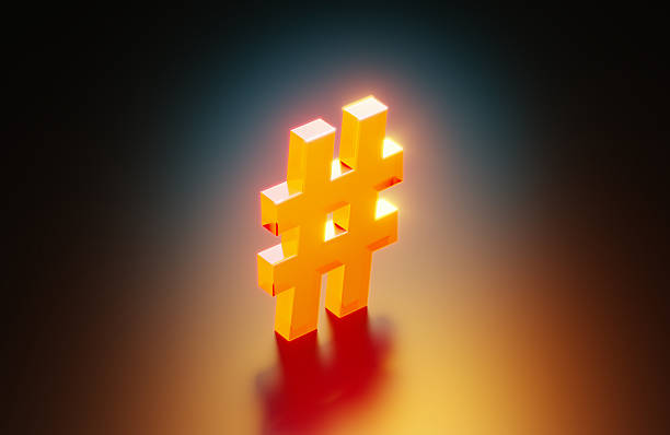Orange colored hashtag symbol glowing on black background.