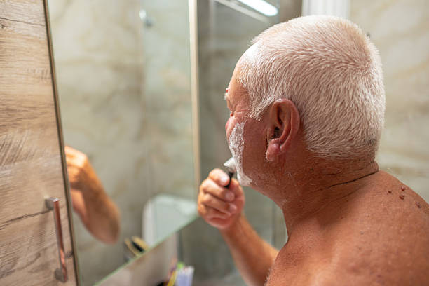 istock Elderly man is shaving with care 2248476799
