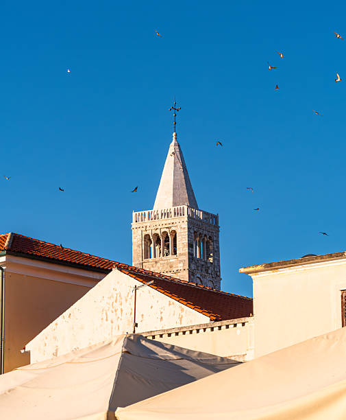 Church Steeple and Birds Against Blue Sky