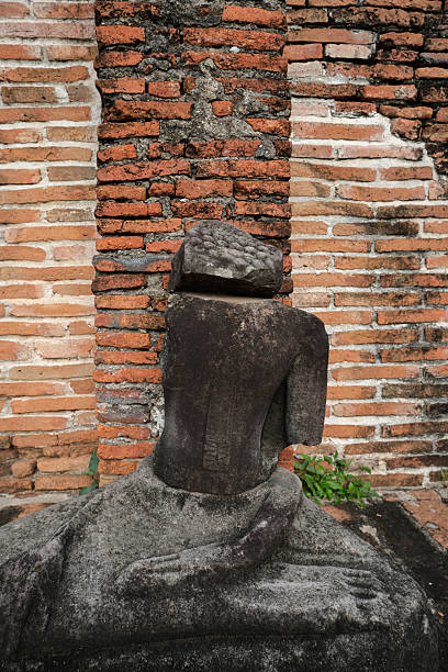 istock An ancient Buddha image remains against an ancient wall. 2248478429