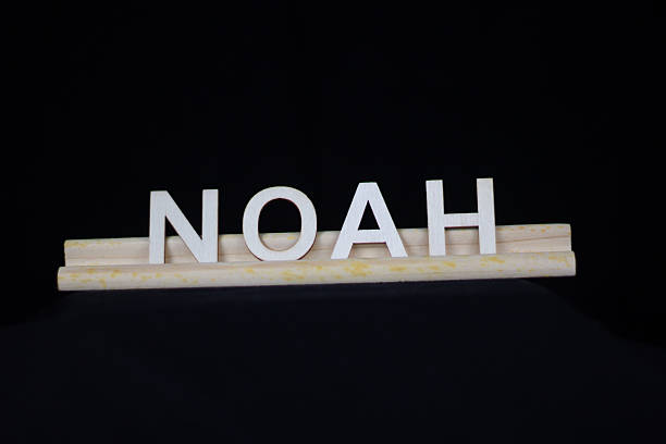 Noah traditional boy name in plain wooden letters on a tile rack isolated on a black background