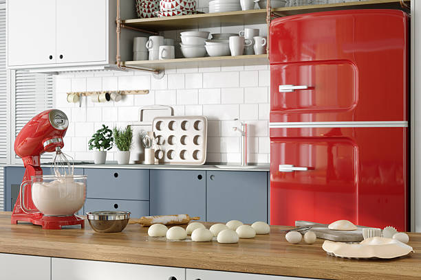 Modern kitchen interior with baking ingredients and tools arranged on a wooden countertop. A red stand mixer with dough inside sits next to bowls, dough balls, and baking utensils, creating a home baking scene. In the background, a retro-style red refrigerator, white tile backsplash, and neatly organized kitchen shelves add to the clean and stylish look of the space.