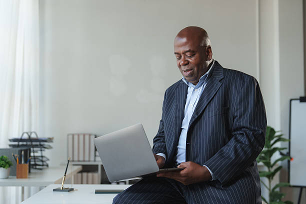 istock Mature black business executive working on laptop 2248480138