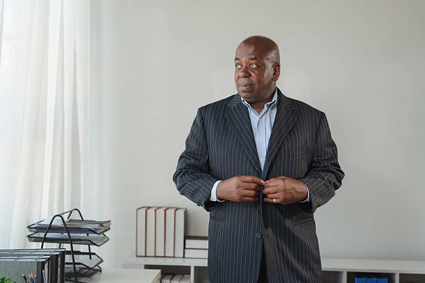 istock African american businessman buttoning suit jacket in office 2248480146