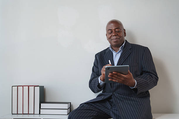 istock Senior black businessman using digital tablet with stylus 2248480159