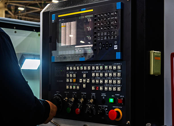 istock Hand operates CNC machine control panel in factory setting. Close-up view of screen, buttons, and dials for manufacturing automation and precision engineering, highlighting modern industrial technolog 2248481043