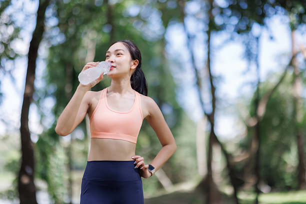 istock Young woman hydrating during outdoor exercise workout 2248481463