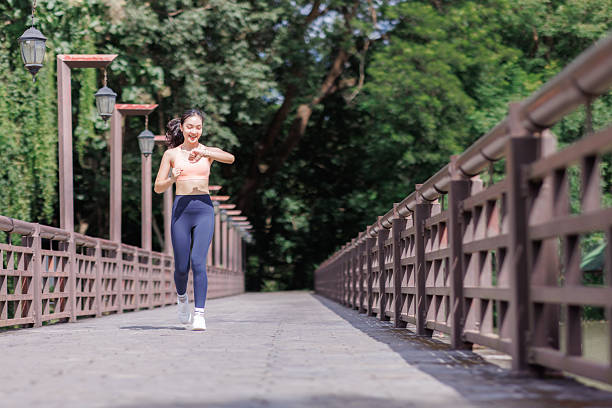 istock Woman jogging checking fitness progress on smartwatch 2248481664