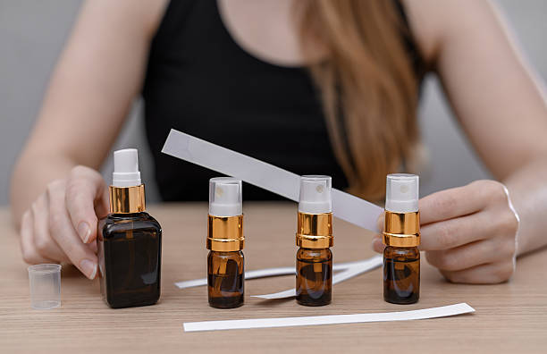 istock Women's perfumes in dark bottles with atomizers, blotter for testing, searching for your scent 2248482596