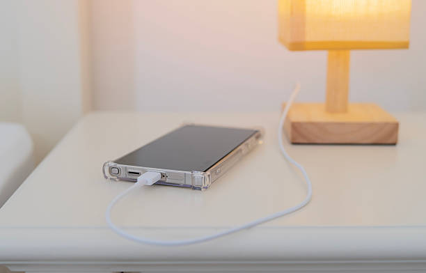 istock Smart phone charging battery by the usb charger socket built in on the bedside table 2248484967