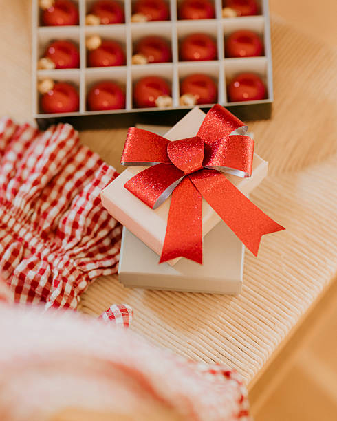 Christmas gift backgrounds still life of gifts on a chair at home with checkered pajamas ganging on it.