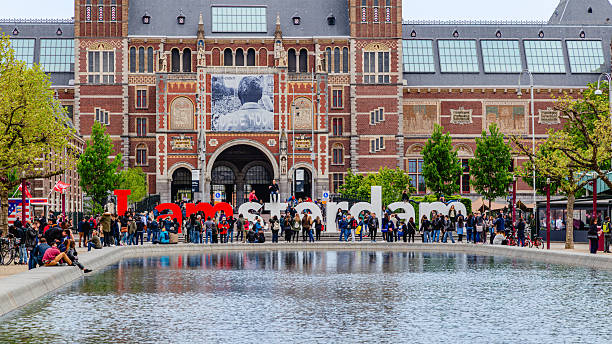 Amsterdam, Netherlands - April 21, 2023: Facade of the Rijksmuseum Dutch national museum with a banner advertising a special exhibition of Vermeers paintings