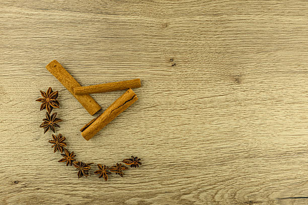 Cinnamon sticks and star anise on a wooden board in the kitchen, a spice for winter tea