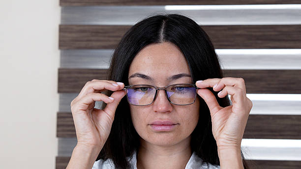 istock Woman is putting on her glasses 2248486208