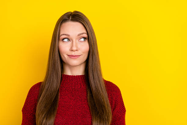 istock Portrait of attractive minded cheery long-haired girl looking aside thinking copy empty space isolated over bright yellow color background 2248486992