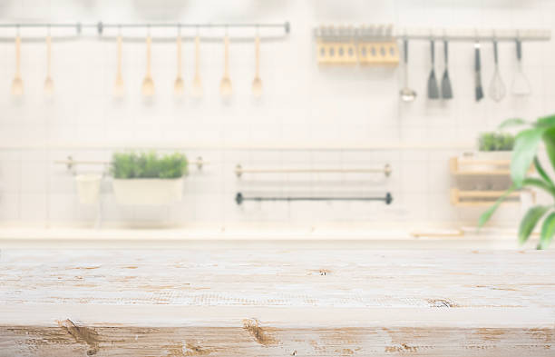 istock White vintage rustic wood table island with cozy white wall kitchen background for design product display 2248489307