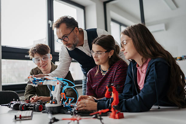 istock High school students working on robotics project with their teacher. 2248490203