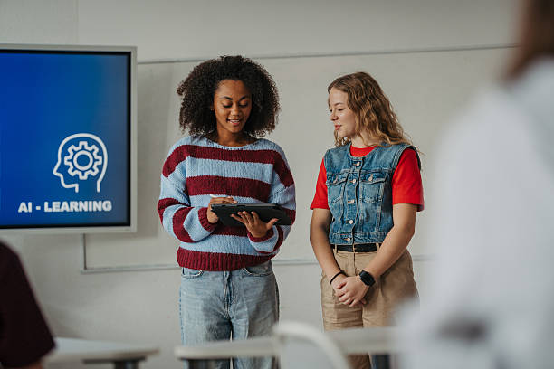 istock Teen girls presenting AI learning project in classroom. 2248490488
