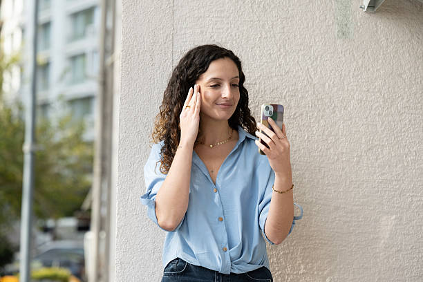 istock Young woman talking on cell phone on balcony. 2248492358