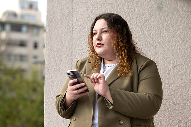 istock Young woman talking on cell phone on balcony. 2248493752