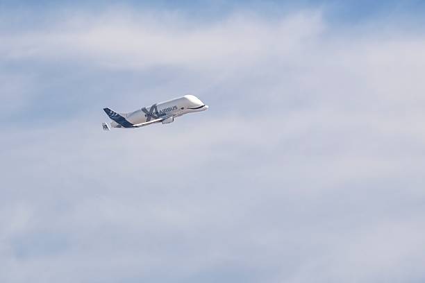 Madrid, Spain; 10-28-2025: Airbus Beluga ascending after takeoff, captured in flight against a soft cloudy sky. Ideal for aviation, aerospace and cargo transport imagery