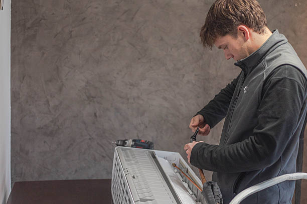 istock The installer is installing an air conditioner 2248498798