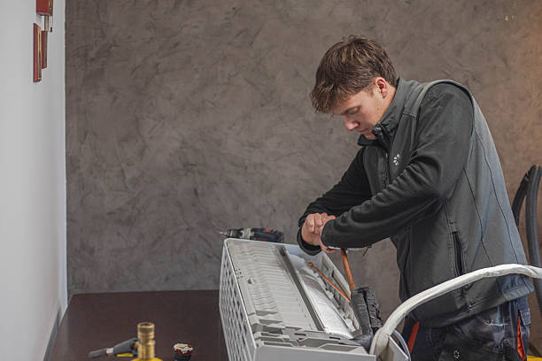 istock The installer is installing an air conditioner 2248498809