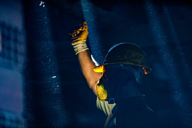 Sao Paulo, Brazil, June 10, 2024. Construction site, silhouettes of construction industry workers on scaffolding against the sunset light. Constructing and building industry in Brazil