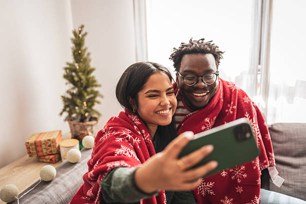 istock Happy diverse couple taking christmas selfie at home 2248503502