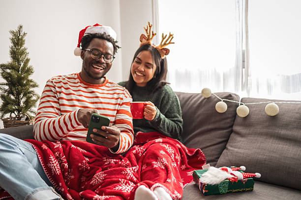 istock Happy couple relaxing using smartphone during christmas holiday 2248503547