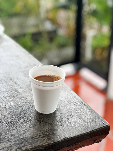 istock Disposable Foam Cup with Hot Beverage on Outdoor Table 2248505581