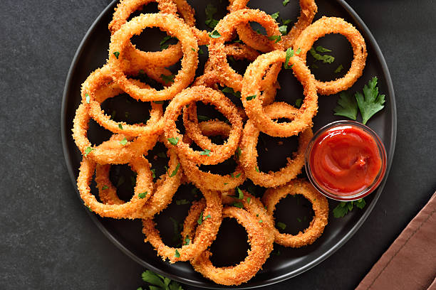 istock Onion rings with tomato sauce on plate 2248507086
