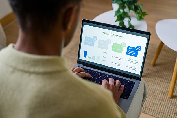 istock Young adult man analyzing marketing strategy on laptop 2248508617