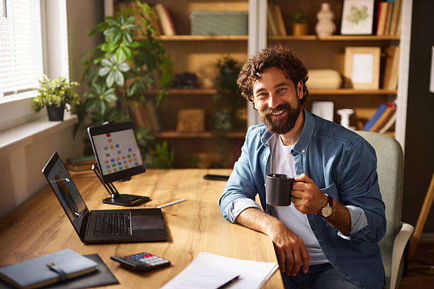 istock Smiling freelancer enjoying a coffee break in his home office 2248509147