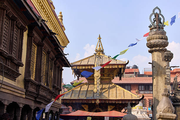 istock Several gilded temple roofs and colorful prayer flags are on display at Swayambhunath, also known as the Monkey Temple, in Katmandu, Nepal. Ancient stone pillars also stand tall. 2248509212