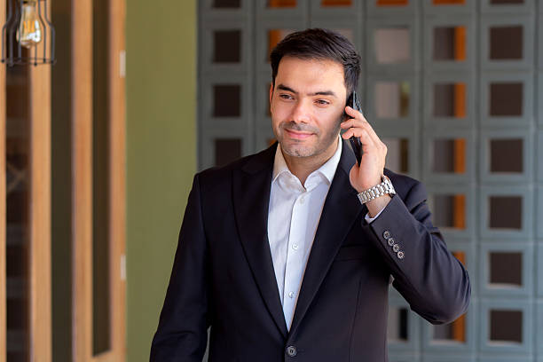 istock Portrait caucasian businessman standing and talking on smart phone with confident expression outside building, business man speaking on smartphone with expression, business and communication. 2248513150