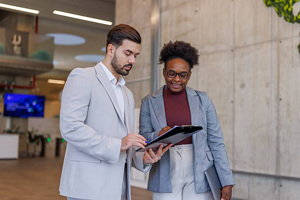 istock Business colleagues collaborating on documents in modern office 2248516661