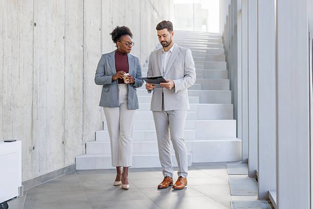 istock Business colleagues collaborating while walking in modern office 2248516770