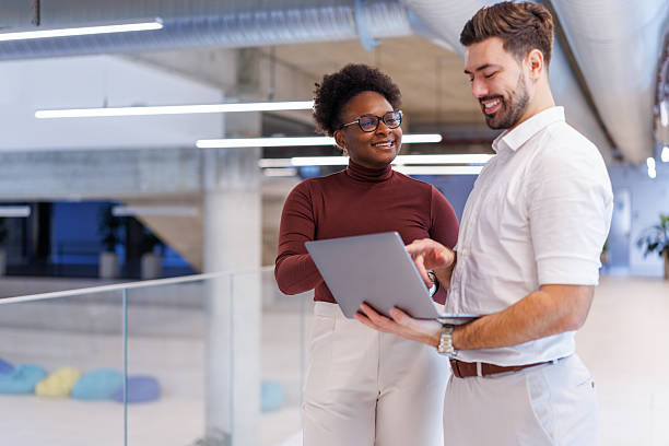 istock Diverse business colleagues collaborating on laptop in modern office 2248516935