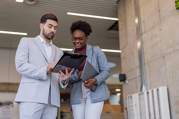 istock Diverse business colleagues reviewing documents in modern office 2248516936