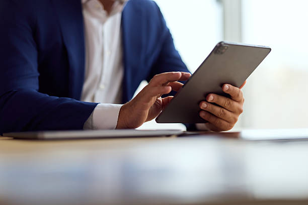 istock Professional Businessman Using Tablet in Modern Office Setting for Productivity and Focus 2248517159