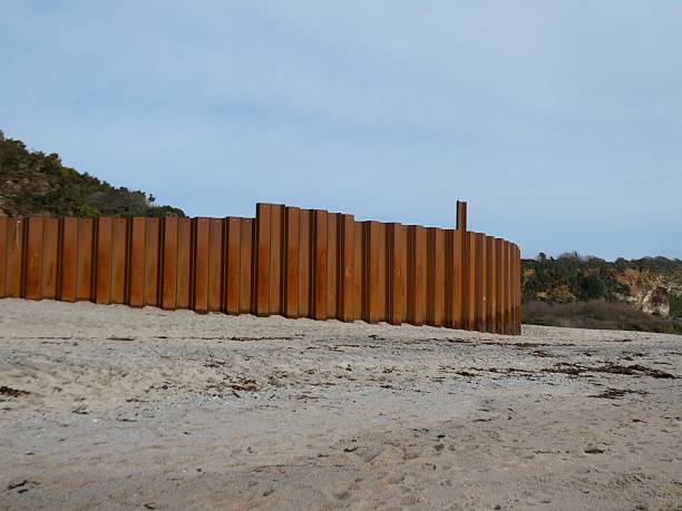 istock Tall rusty sea defence wall on Carlyon Bay beach 2248517186