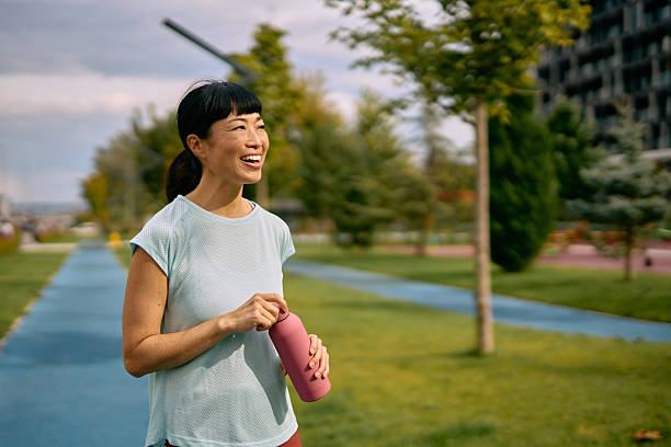 istock Asian woman taking a break from exercising in park 2248517846