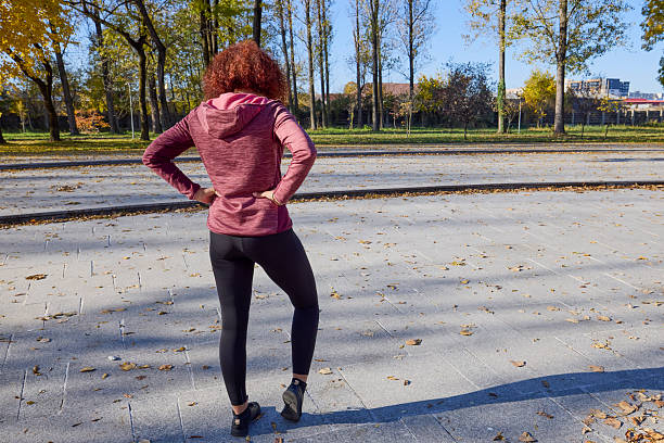 istock A middle-aged woman in the park is doing warm-up exercises before exercising. 2248520014