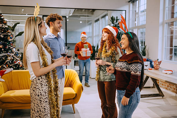 istock Office colleagues celebrating Christmas with red wine 2248520306
