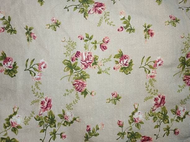 istock Roses floral pattern background on beige canvas fabric textile. Pink red flowers design wallpaper texture. Scrapbook paper backdrop surface. 2248523920